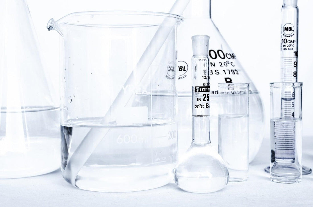 Laboratory glassware with clear liquids illustrating probiotics for weight loss scientific research