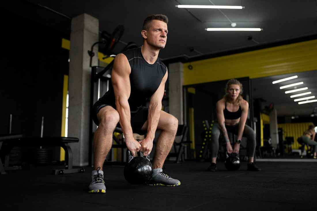 man and woman exercising with kettlebells in gym for muscle recovery and strength training