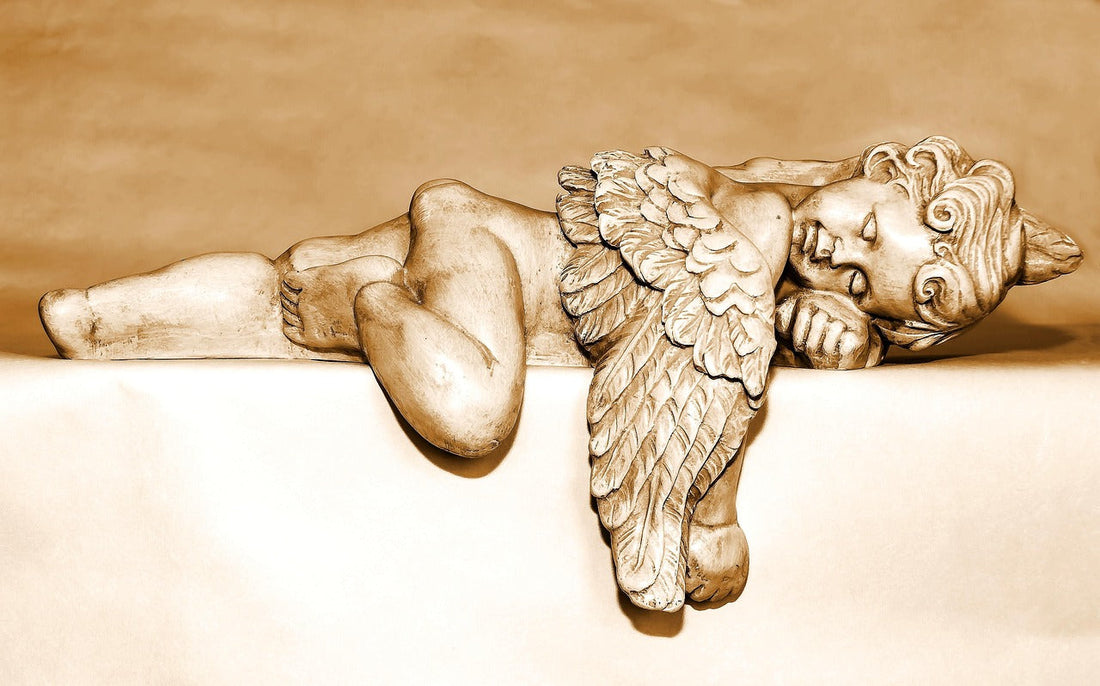 Sleeping angel statue carved in beige stone symbolizing peaceful nighttime habits for deep restful sleep