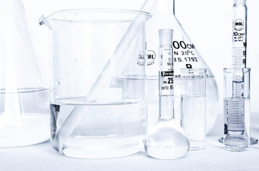 Laboratory glassware with clear liquids illustrating probiotics for weight loss scientific research