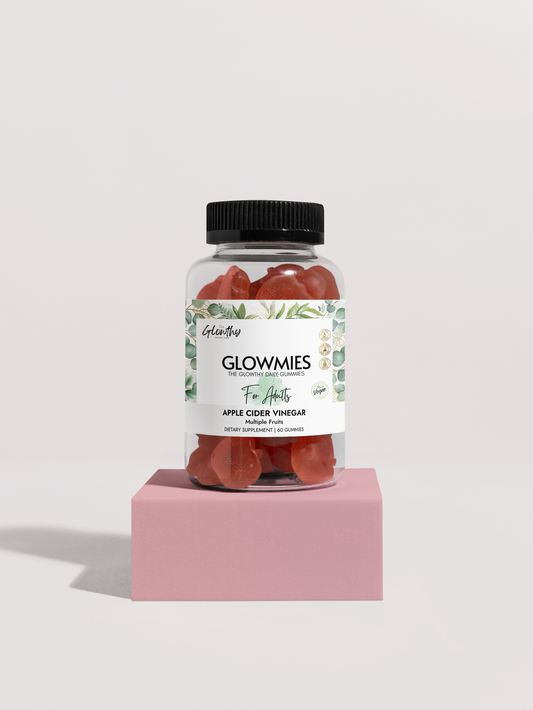 Apple Cider Vinegar Benefits with GLOWMIES Apple Cider Vinegar Gummies formulated to enhance metabolism, support gut health and naturally boost your energy, Gummies in a clear bottle (60 Gummies) on a pink stand.
